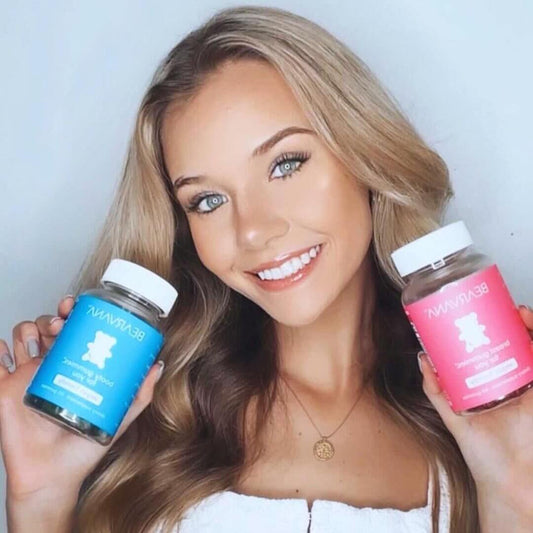 Women’s Support Supplement | Gummies Combo Pack held by a smiling woman, showcasing berry-flavored gummies in blue and pink bottles.