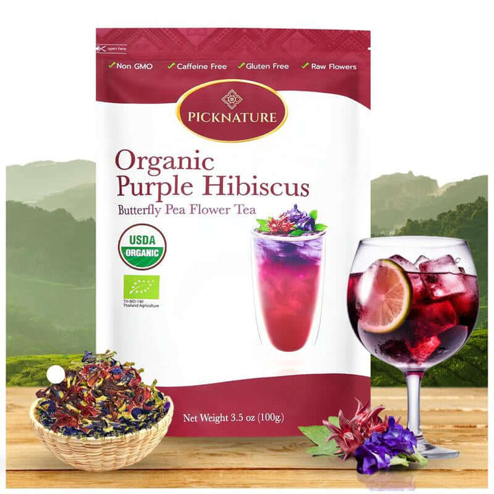 Organic Purple Hibiscus and Butterfly Pea Flower Tea pack with iced tea and dried flowers display.