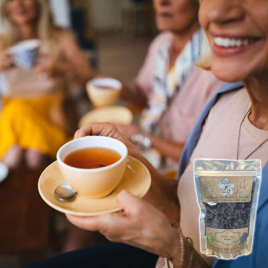 Group of friends enjoying tea together, featuring a cup and a pouch of loose leaf tea.